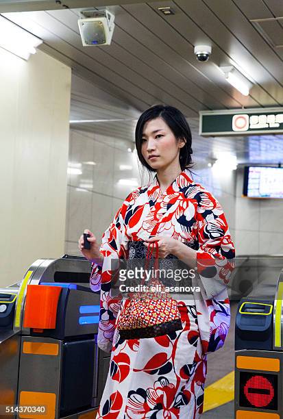 japanese woman wearing a kimono check out in tokyo subway. - japanese exit sign stock pictures, royalty-free photos & images