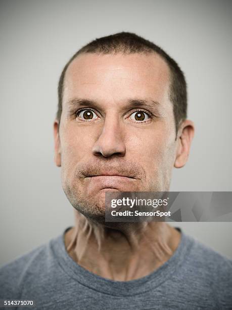 portrait of an american real man. - annoyed face brunnette stock pictures, royalty-free photos & images