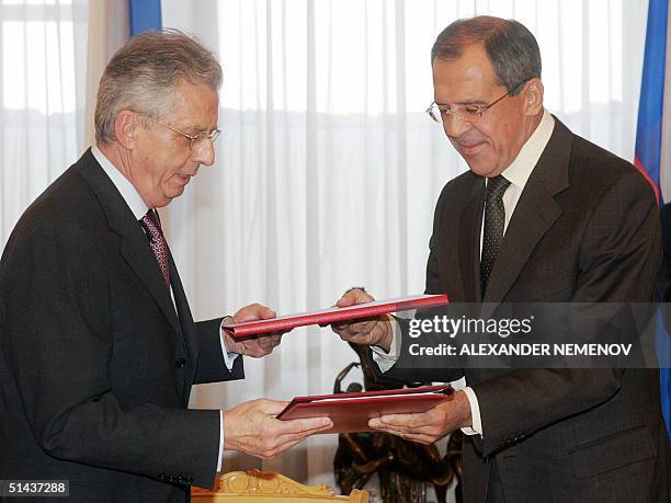 French Ambassador to Russia Jean Cadet and Russian Foreign Minister Sergey Lavrov hand over documents, allowing French troops and military hardware...