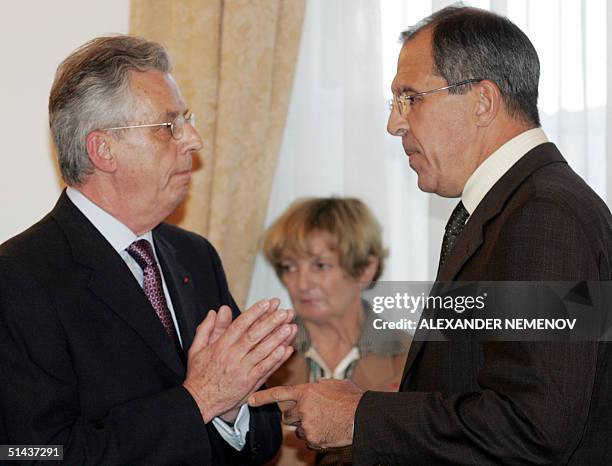 French Ambassador to Russia Jean Cadet and Russian Foreign Minister Sergey Lavrov talk after an official signing ceremony of documents, allowing...