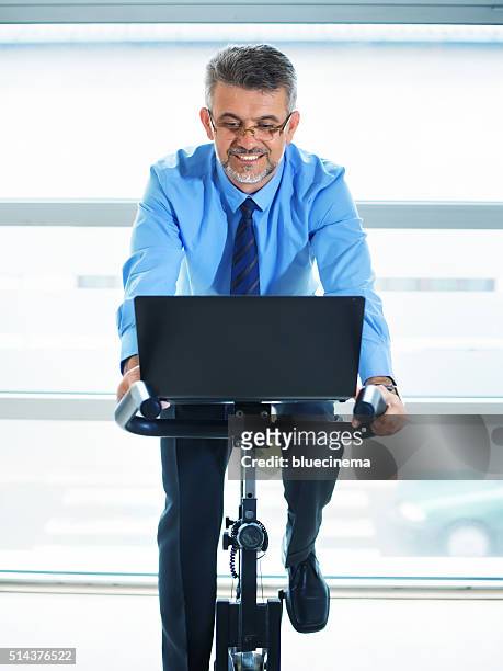 businessman exercising in fitness - peloton stock pictures, royalty-free photos & images