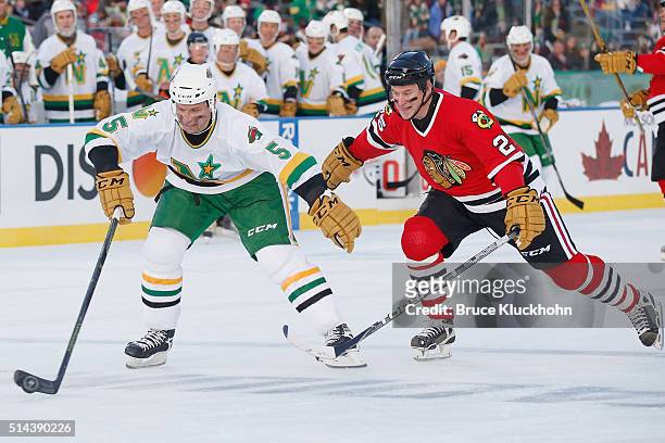 Minneapolis, MN Brad Bombardir of the Minnesota North Stars/Wild skates with the puck while Dave Christian of the Chicago Blackhawks defends during...
