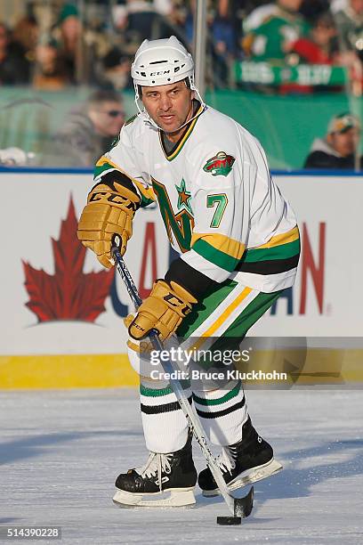 Minneapolis, MN Neal Broten of the Minnesota North Stars/Wild skates with the puck against the Chicago Blackhawks during the Coors Light NHL Stadium...