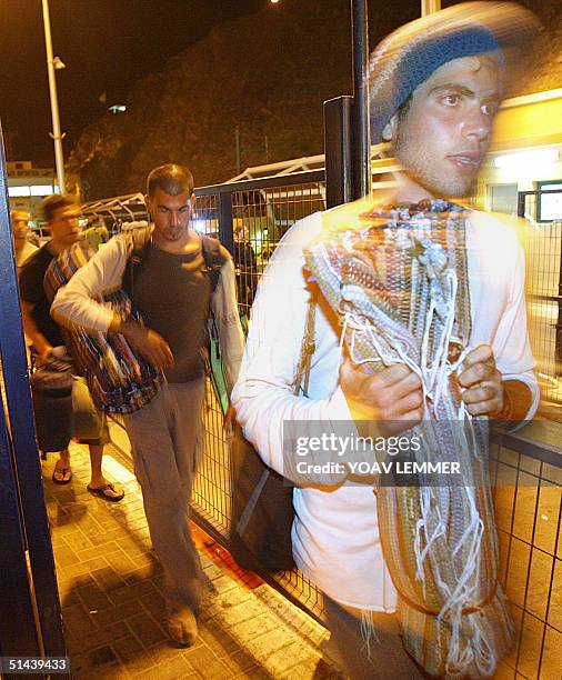 Israelis cross the border into the Israeli town of Eilat from the Egyptian resort of Taba on the Red Sea 08 October 2004. Some 100 people were...