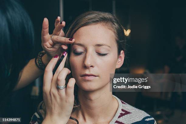 woman having her make up done by a make up artist - sombreador de ojos fotografías e imágenes de stock