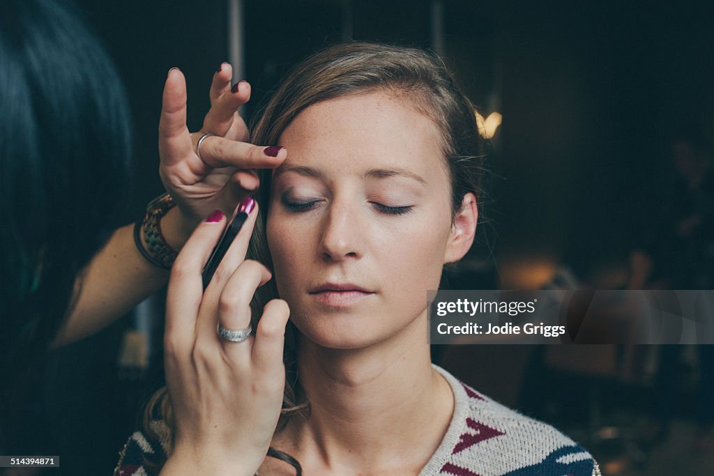 Woman having her make up done by a make up artist