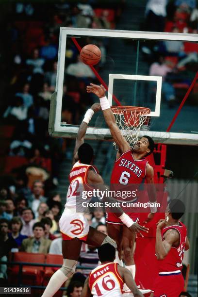 Julius Erving of the Philadelphia 76ers blocks a shot against the Atlanta Hawks during an NBA game ini 1984 at the Omni in Atlanta, Georgia. NOTE TO...