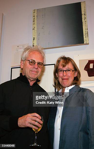 Artists Burt Barr and Nancy Haynes stand beneath her painting "The End of Violence" placed on silent auction at "Art For A Landmine Free World"...
