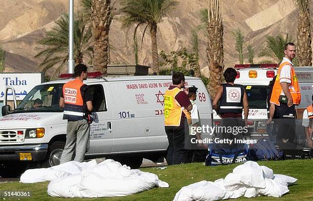 Bodies lie on the grass near emergency in Egyptian resort of Taba on the Red Sea, on October 8, 2004 in Taba, Egypt. Some 100 people were wounded and...
