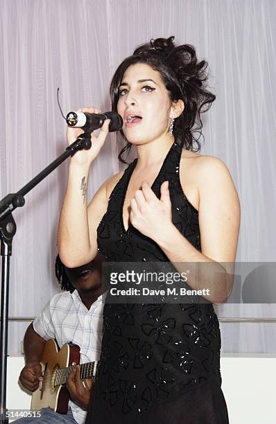 Singer Amy Winehouse performs at the launch of the latest Blackberry product - the 7100 - at the Sanderson Hotel on October 7, 2004 in London. Amy...