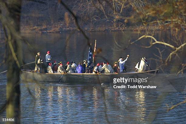 Torch bearer Helen Leaman carries the Olympic Flame in a re-enactment of George Washington crossing the Delaware River during the 2002 Salt Lake...