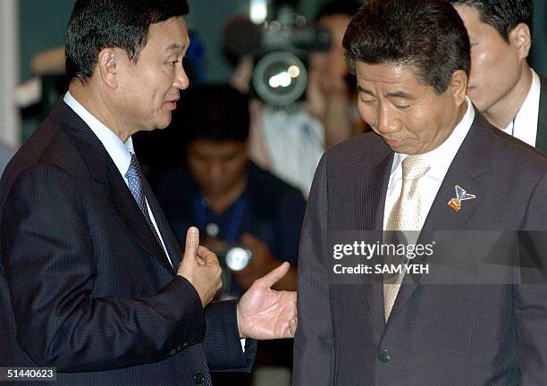 Thai Prime Minister Thaksin Shinawatra speaks to South Korean President Roh Moo-Hyun during the second closed session of the 5th Asia-Europe Meeting...