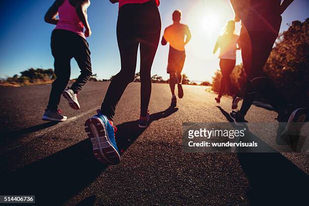 athletes doing a jogging workout outdoors - group fitness stockfoto's en -beelden