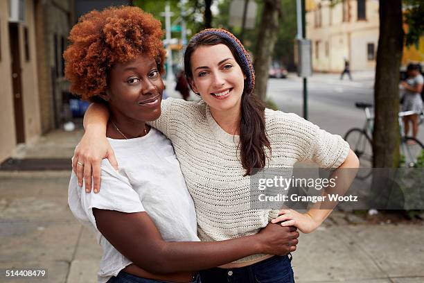 women hugging on city street - couple close up street stock pictures, royalty-free photos & images