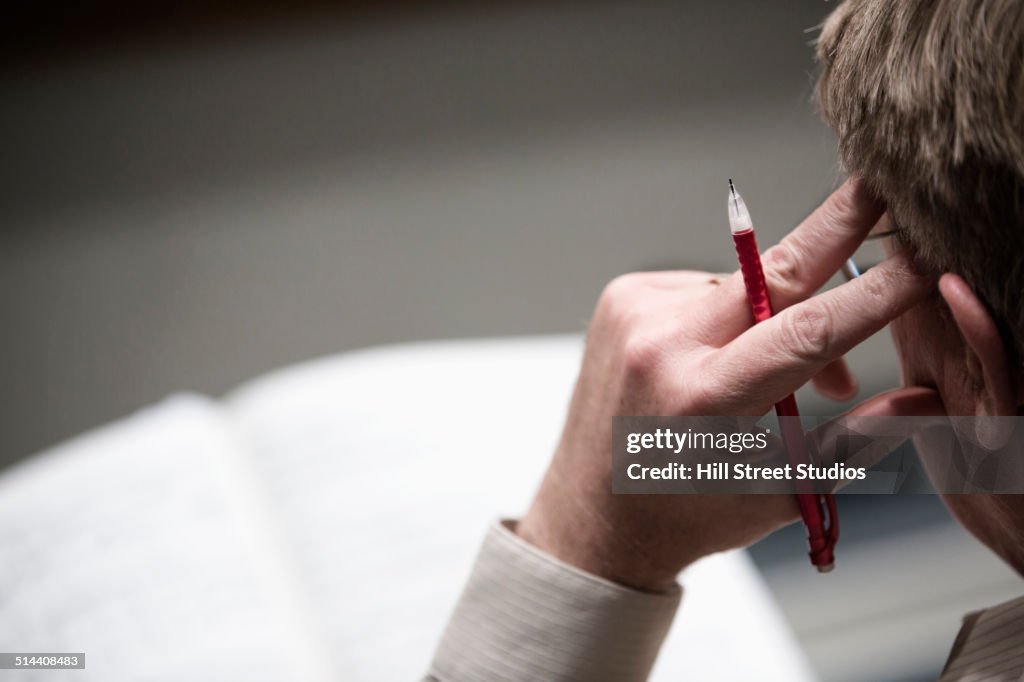 Close up of man thinking at desk