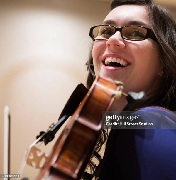 caucasian student playing violin - soloist stock-fotos und bilder