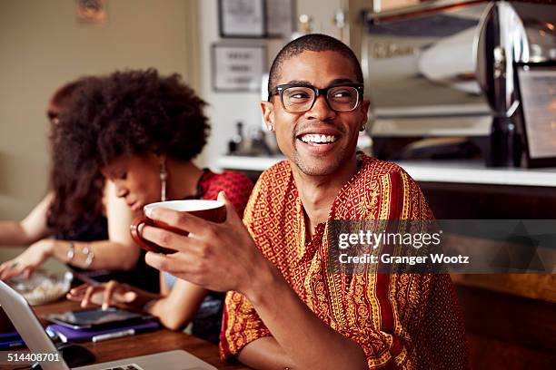 man having cup of coffee in cafe - new york cafe stock-fotos und bilder