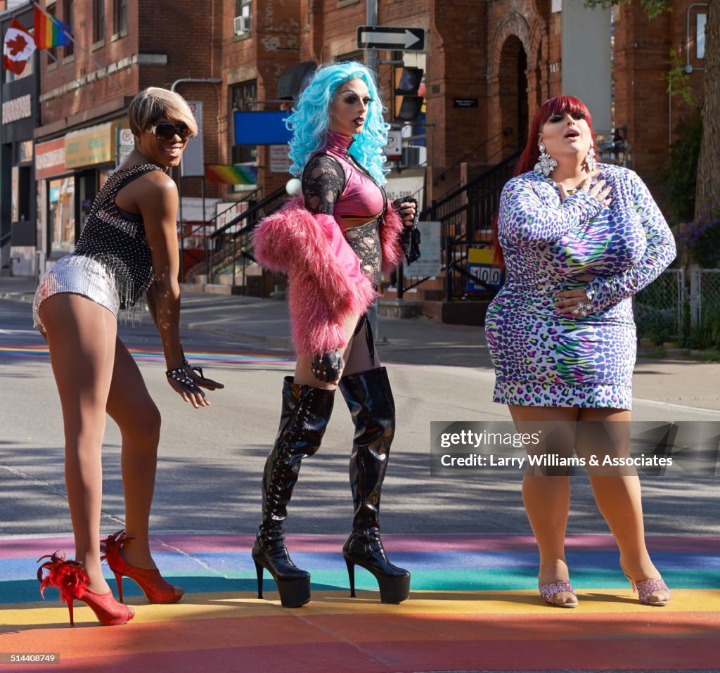 Drag queens posing on rainbow pavement on city street, Toronto, Ontario, Canada