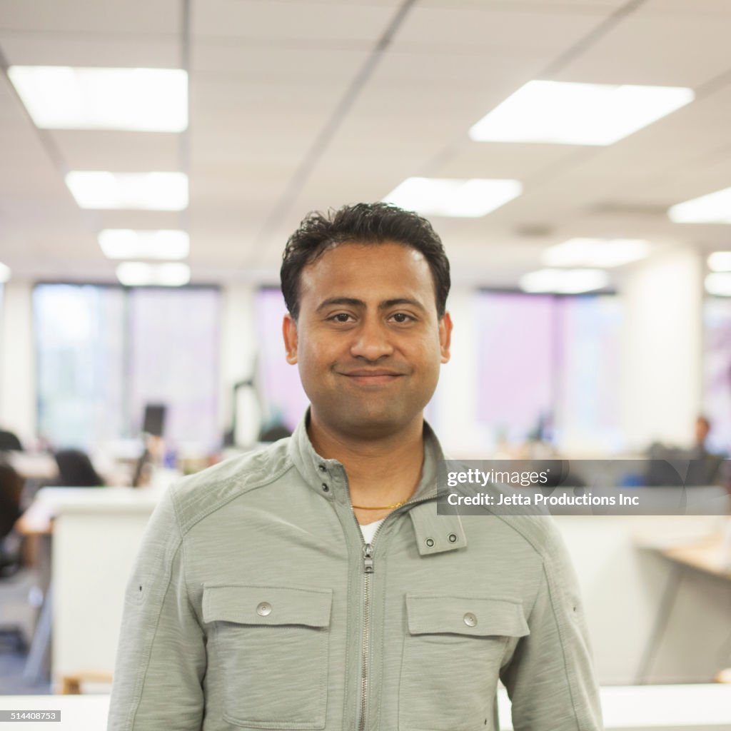 Asian businessman smiling in office