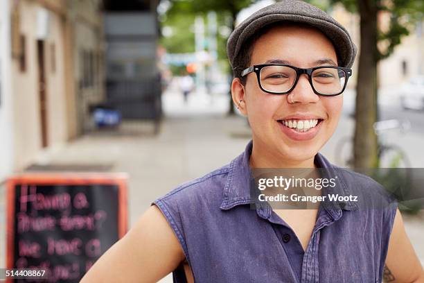 mixed race woman smiling on city street - new york black and white stock pictures, royalty-free photos & images