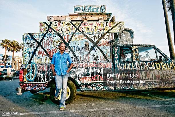 older black woman standing by decorated truck - graffiti hintergrund stock pictures, royalty-free photos & images