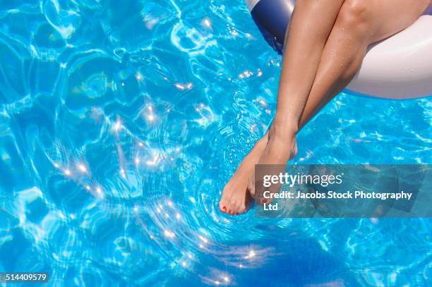 hispanic woman's legs relaxing in swimming pool - hot legs stock pictures, royalty-free photos & images