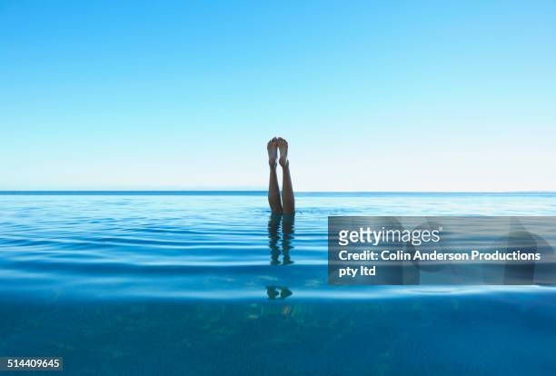 feet of caucasian girl swimming in tropical ocean - tween heels stock pictures, royalty-free photos & images
