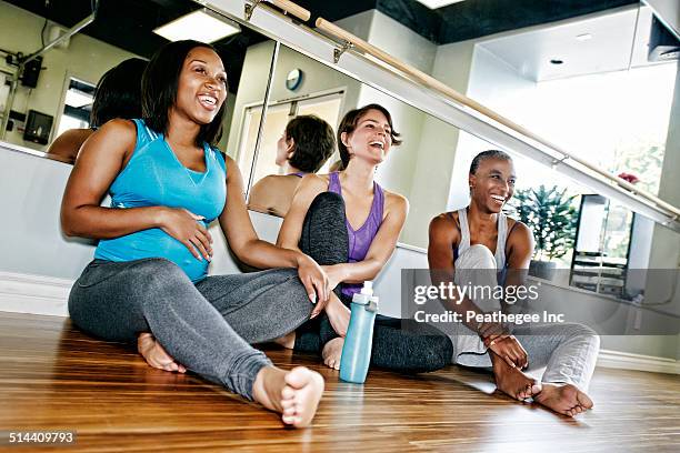 women relaxing together in yoga studio - active lifestyle los angeles stock-fotos und bilder