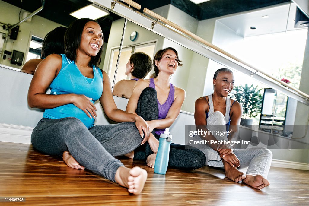 Women relaxing together in yoga studio