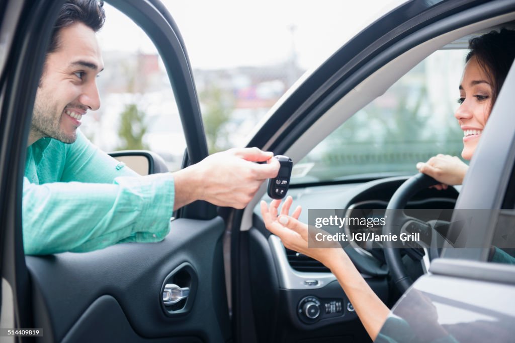 Man giving girlfriend keys to car