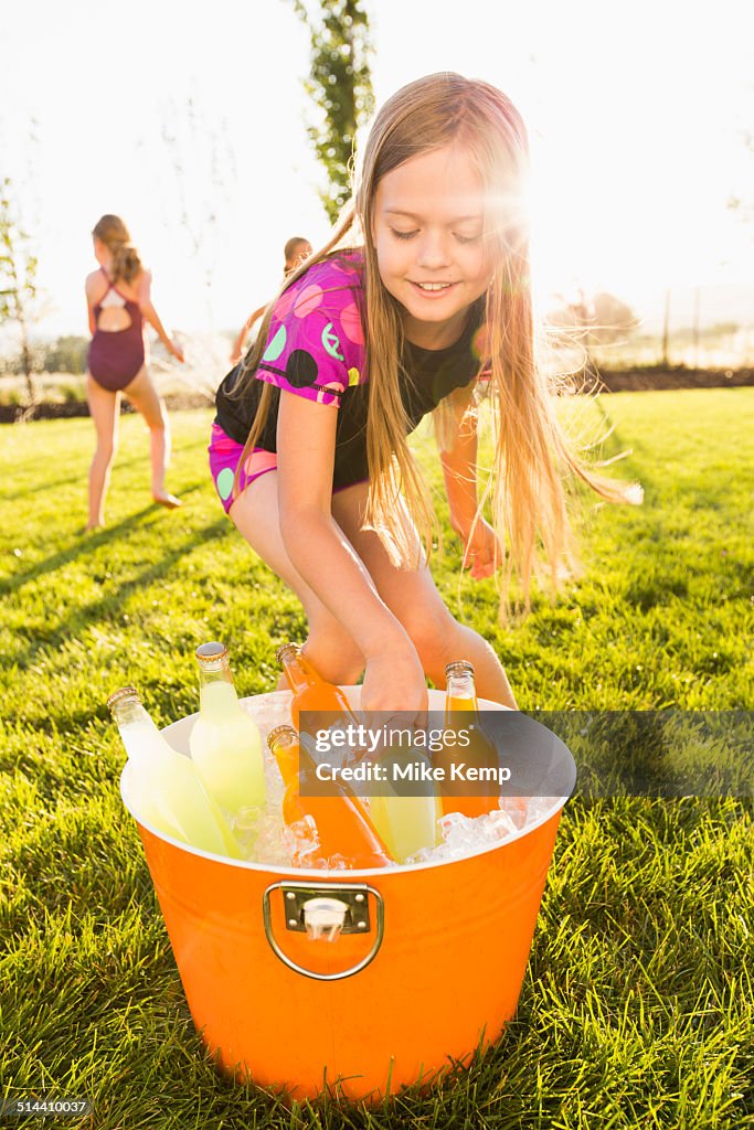 Caucasian girl drinking soda in backyard