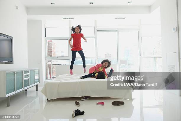 black girls jumping on bed - lwa dann tardif bed stock pictures, royalty-free photos & images