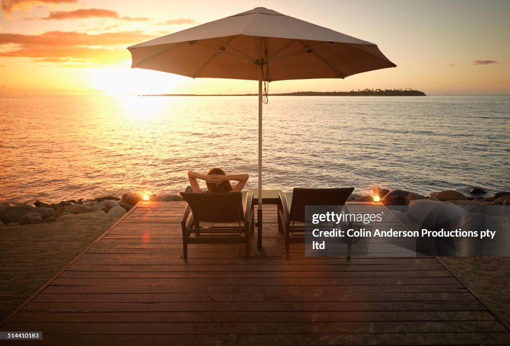 Caucasian woman admiring sunset over water, Denarau Island West, Nadi, Fiji