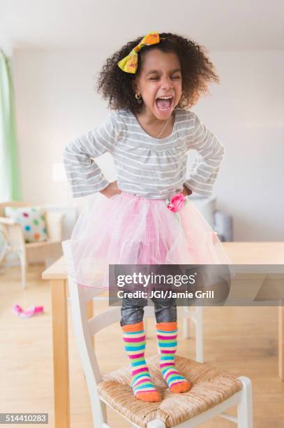 african american girl shouting on chair - funny black girl fotografías e imágenes de stock