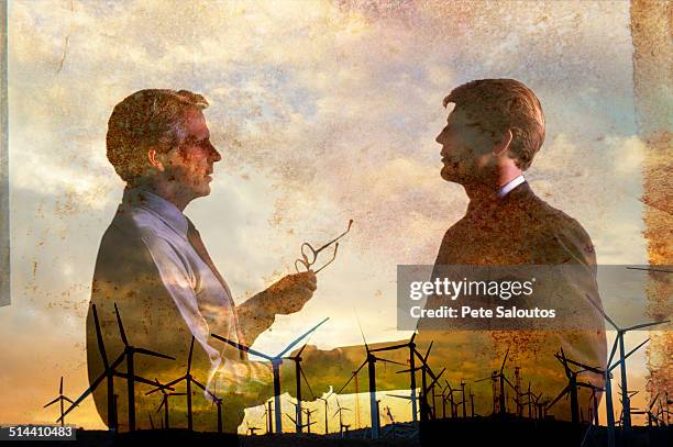 double exposure of businessmen and wind turbines - climate agreement stock pictures, royalty-free photos & images