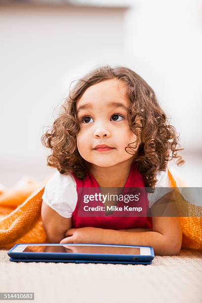 mixed race girl using tablet computer on living room floor - 3 years brunette female alone caucasian stock pictures, royalty-free photos & images