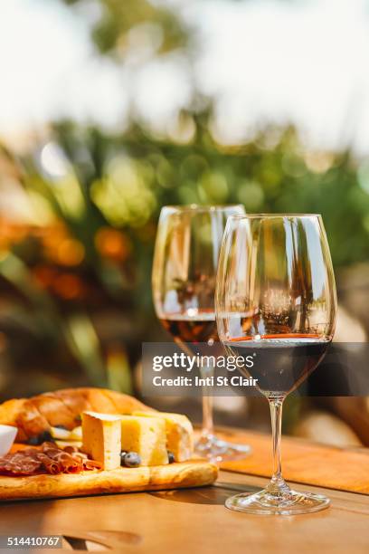 glasses of wine with cheese and meat board - cheese and wine stock-fotos und bilder