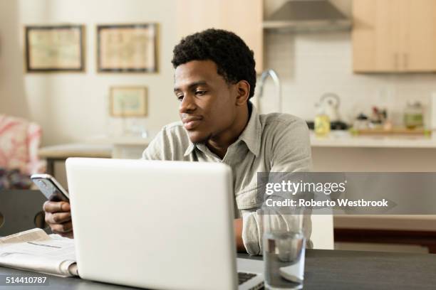 black businessman working at breakfast table - newspaper luxury bildbanksfoton och bilder