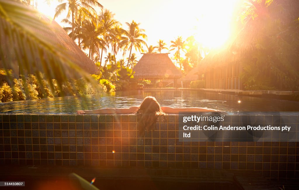 Caucasian girl relaxing in swimming pool