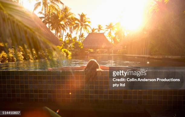 caucasian girl relaxing in swimming pool - fiji hut stock pictures, royalty-free photos & images