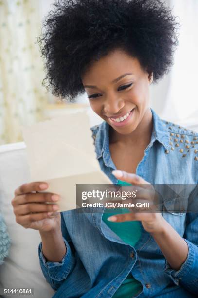 african american woman reading letter - reading mail stock pictures, royalty-free photos & images