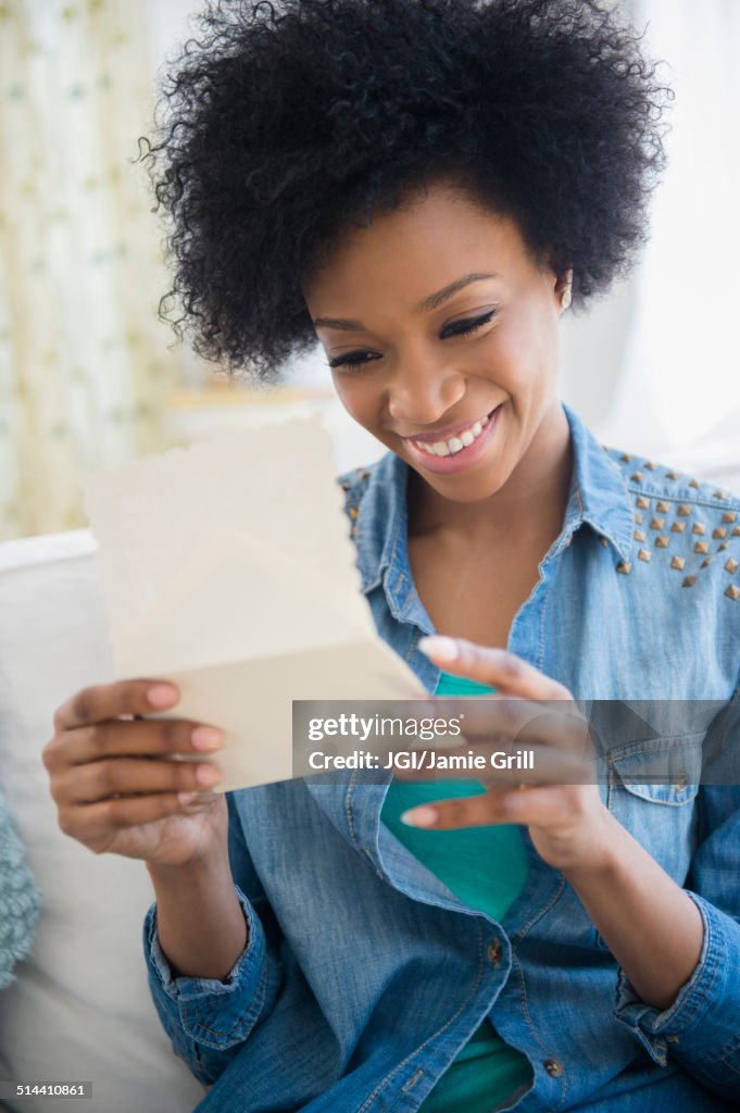 African American woman reading letter
