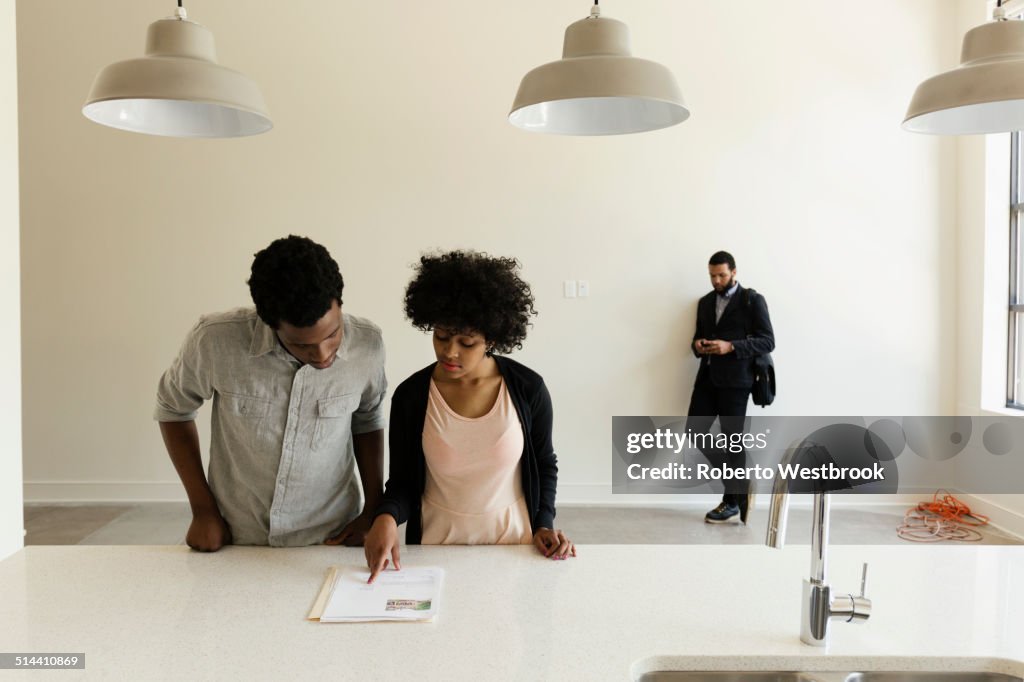 Couple reading paperwork in new house