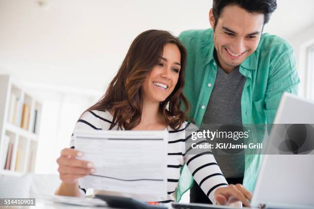 couple paying bills together online - bills payment stock-fotos und bilder