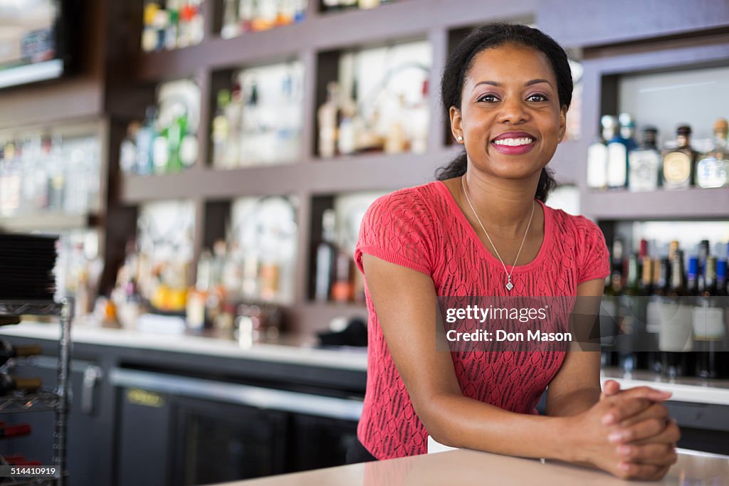 African American bartender smiling in bar