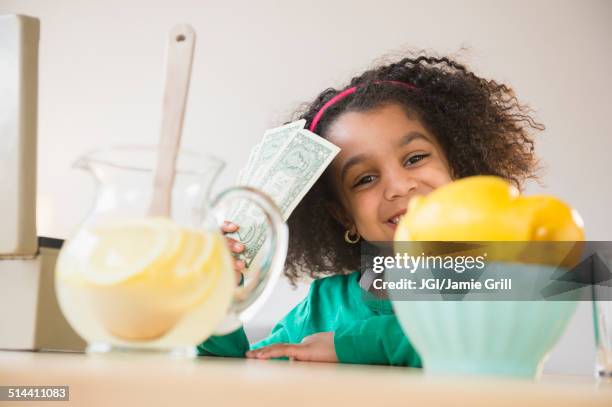 african american girl selling lemonade - african american money stock pictures, royalty-free photos & images