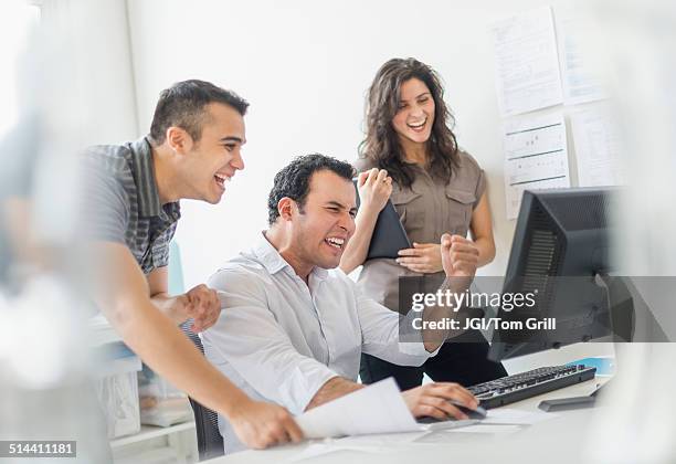 hispanic business people cheering together in office - female with group of males stock-fotos und bilder