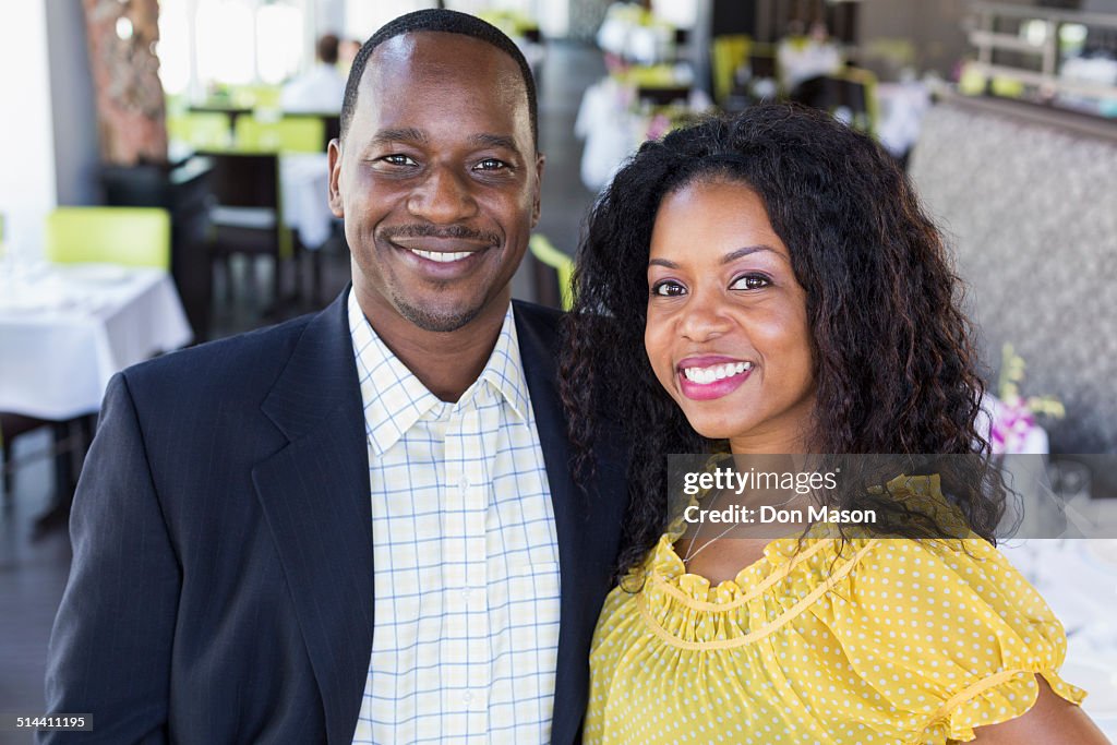 African American couple smiling in restaurant