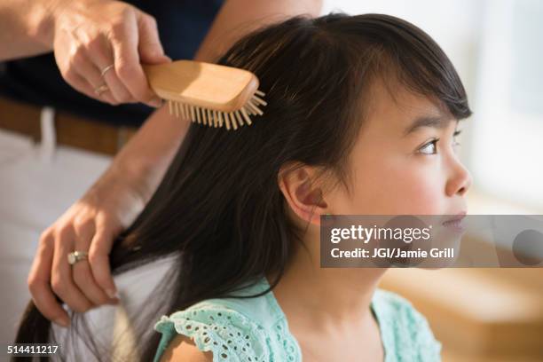 mother brushing daughter's hair - brushing hair stock pictures, royalty-free photos & images