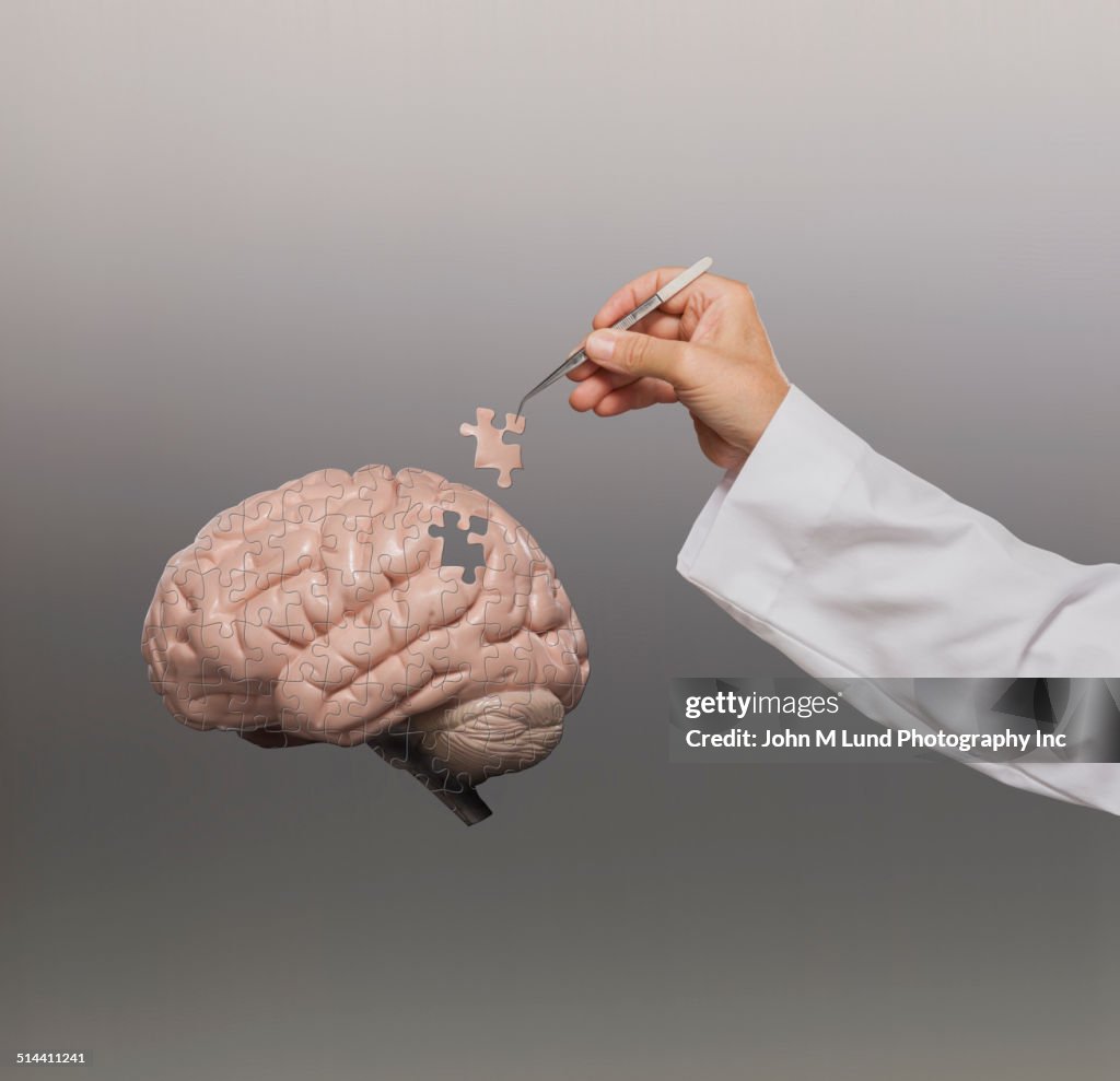 Doctor putting brain puzzle together